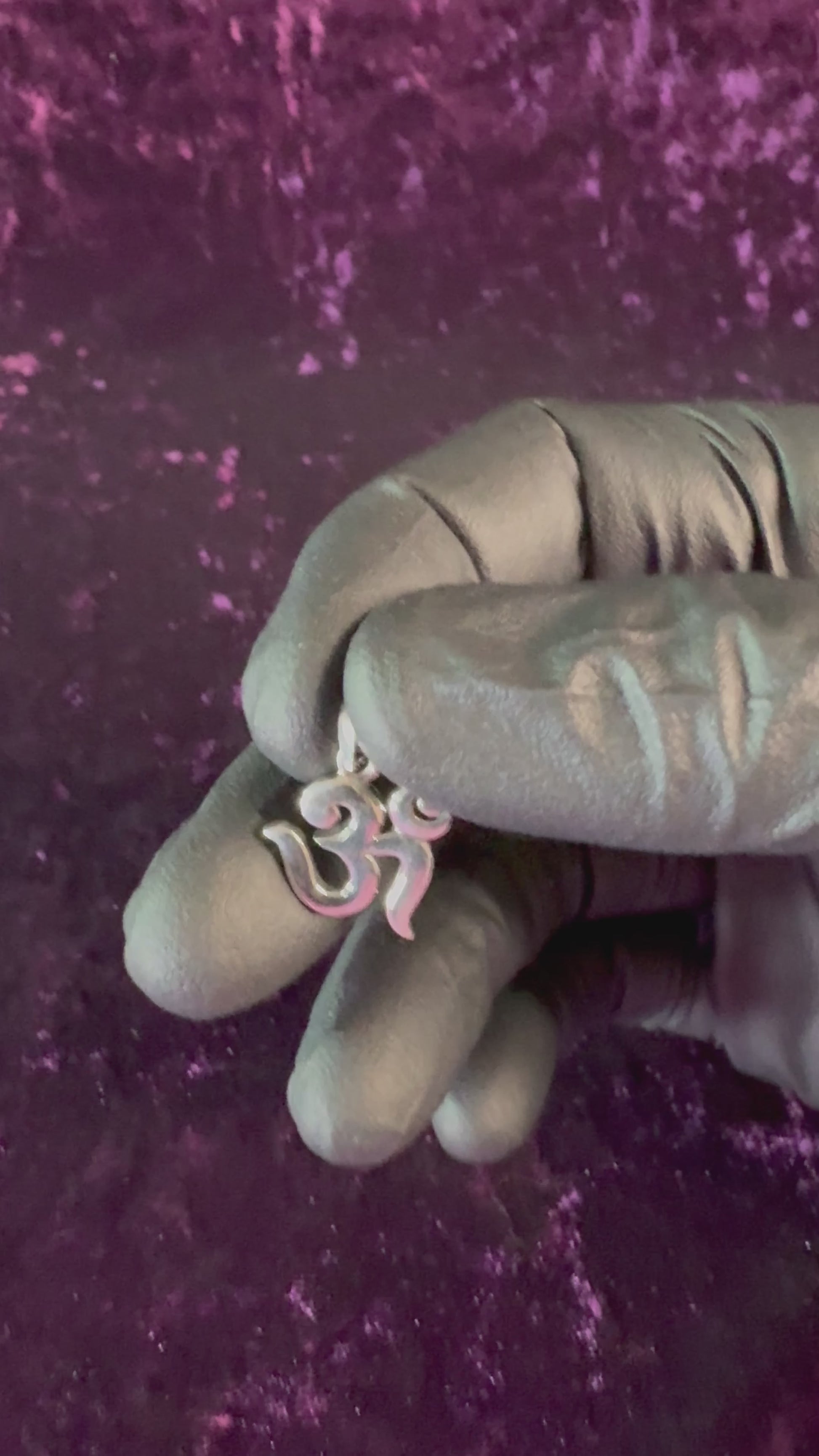 Modern Om Symbol Sterling Silver Pendant in hand