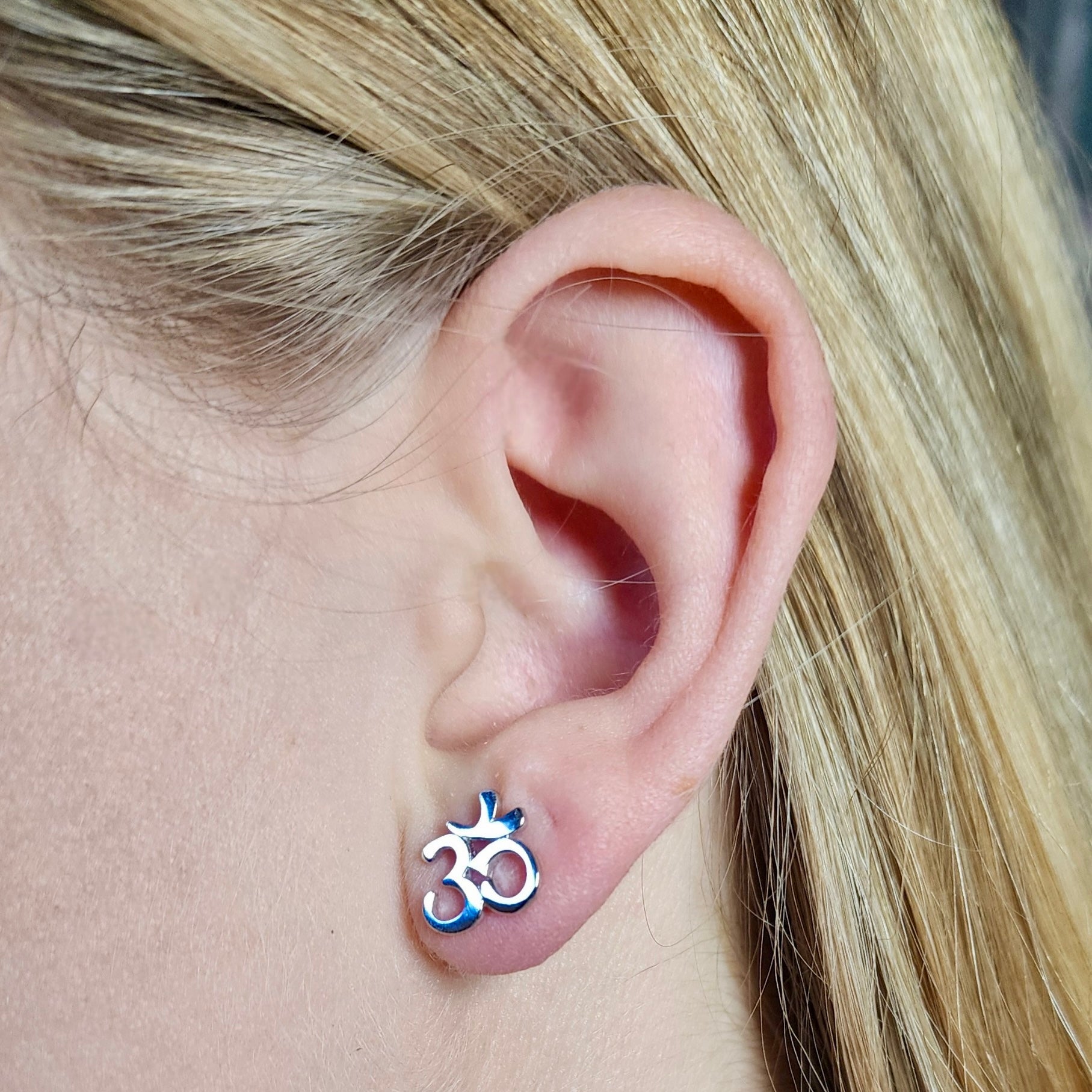 Om Symbol Stud Earrings in Sterling Silver on Ear aesthetic