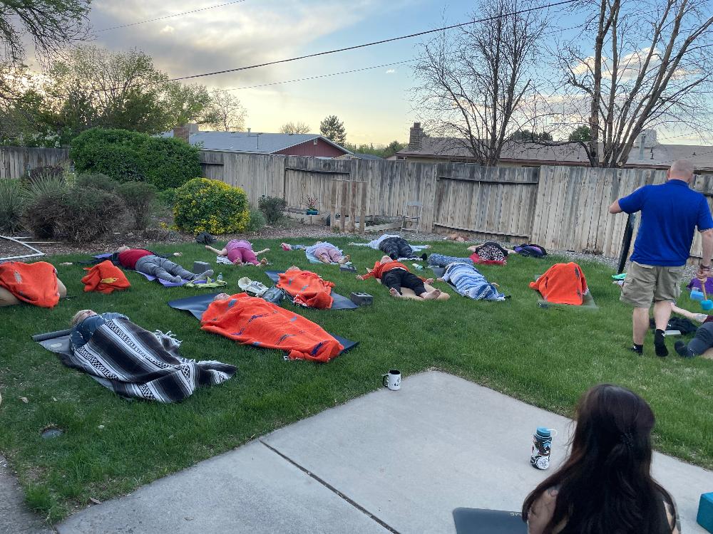 Bhakti House Yoga Studio slow flow yoga savasana in backyard during full moon ceremony