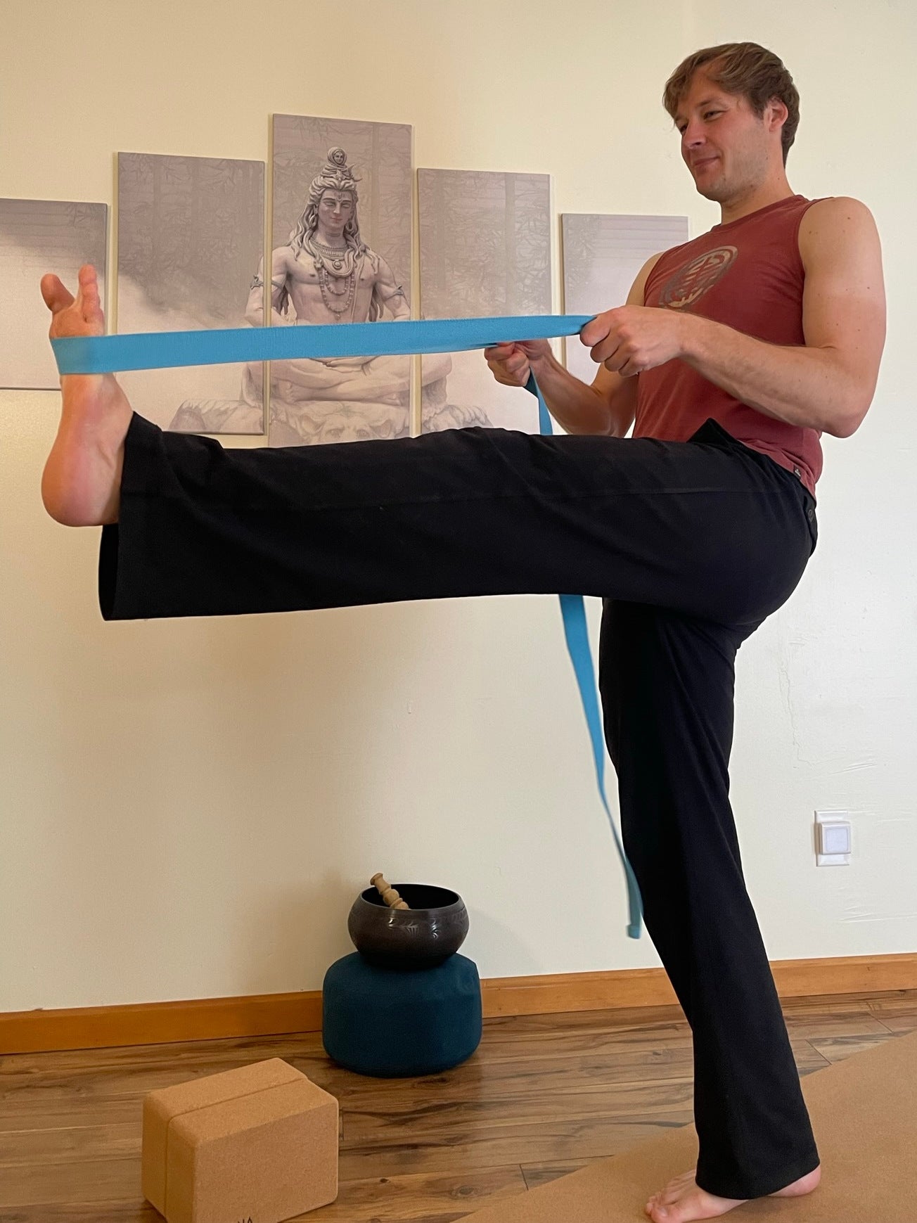 Odyssey Yoga Strap in color Turquoise used to support a standing leg raise posture
