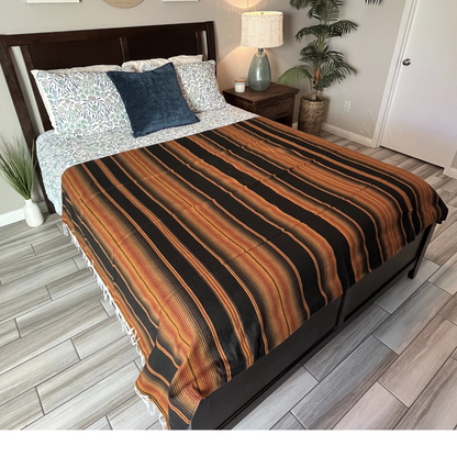 Brown Isla Serape Yoga Blanket Laid Across Bed