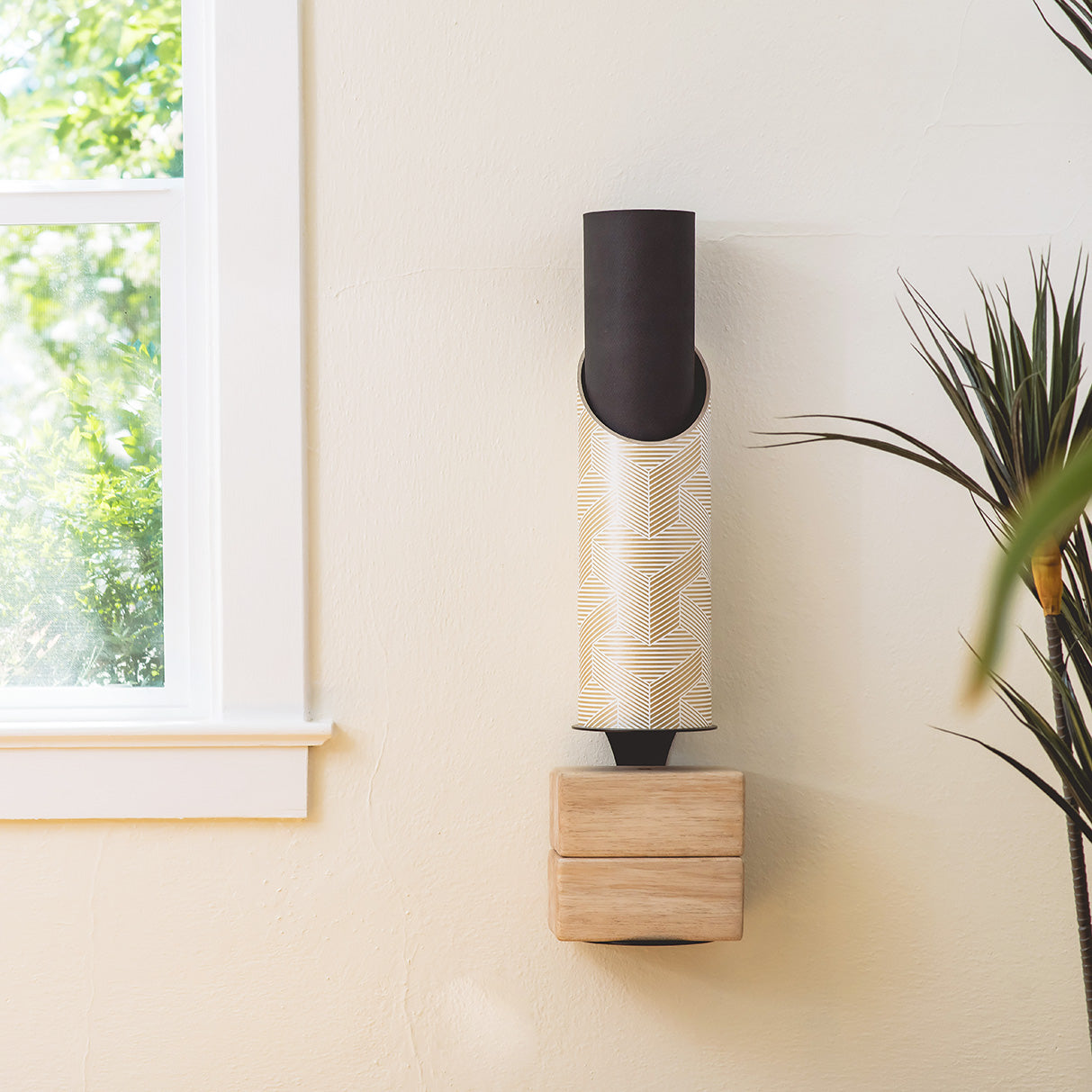 Souzi Yoga Mat Tube in Use on Wall with Yoga Mat and 2 Blocks Stored