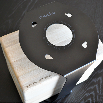 Close-up of the Black Homi yoga block floor stand