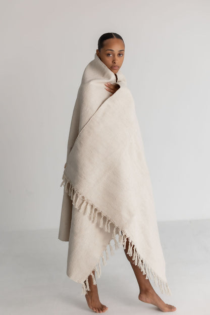 Cream organic cotton yoga blanket shown in use